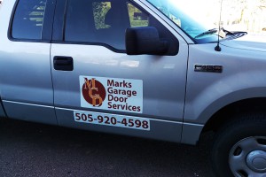 Mark's Garage Door Services truck with logo and phone