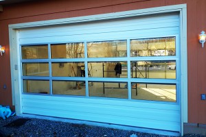 Custom automatic garage door exterior with window panes