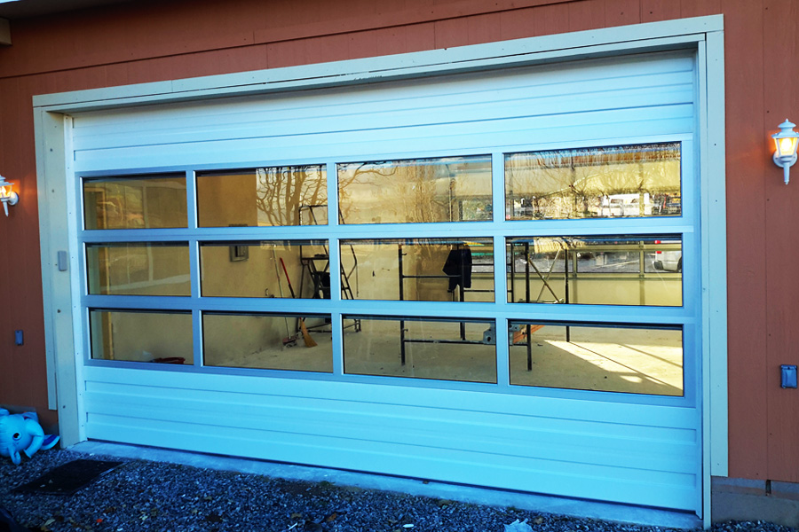 Custom automatic garage door exterior with window panes