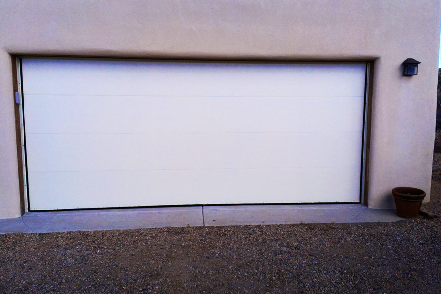 white automatic garage door on stucco house