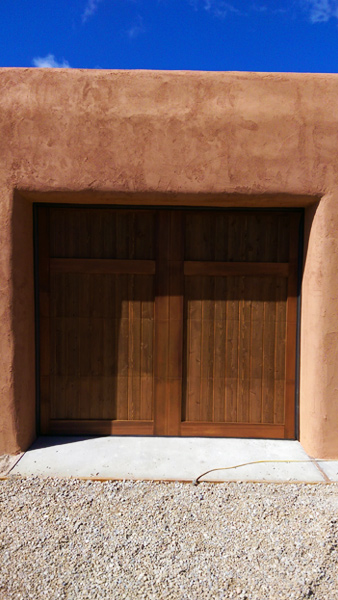 southwestern dark stained wood panel garage door