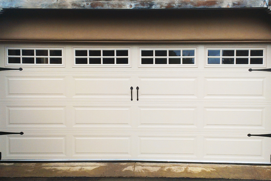 white metal paneled garage door with windows