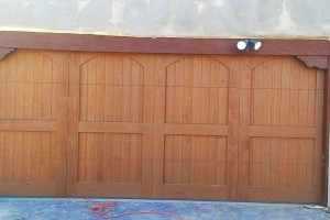 wide cherry stained wood garage door