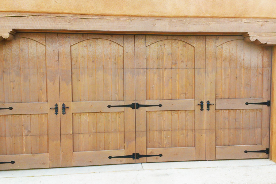 wooden double garage door with metal handles and braces