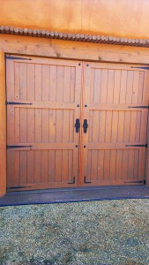 three wood panel with black metal braces garage door