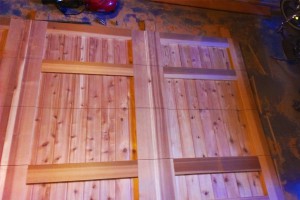 progress shot of stained wood panels for garage installation on tarp