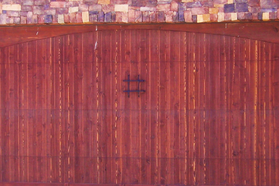 cherry stained wooden door on brick building