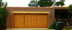 wood paneled two car garage door on stucco house