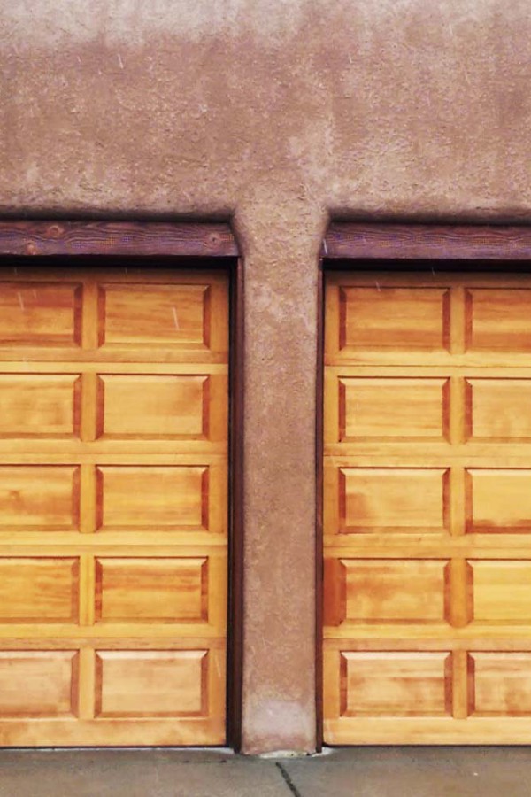 custom southwestern wooden two door garage with stucco
